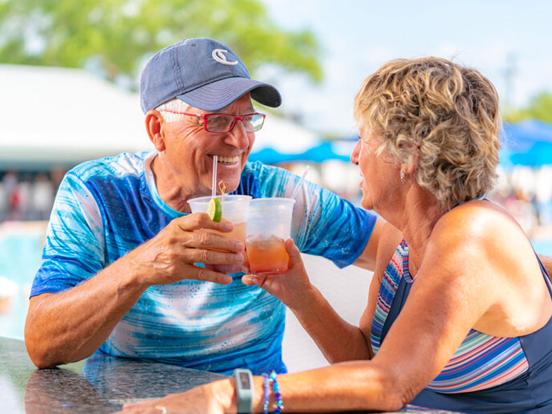 Guests enjoying drinks beside the resort pool