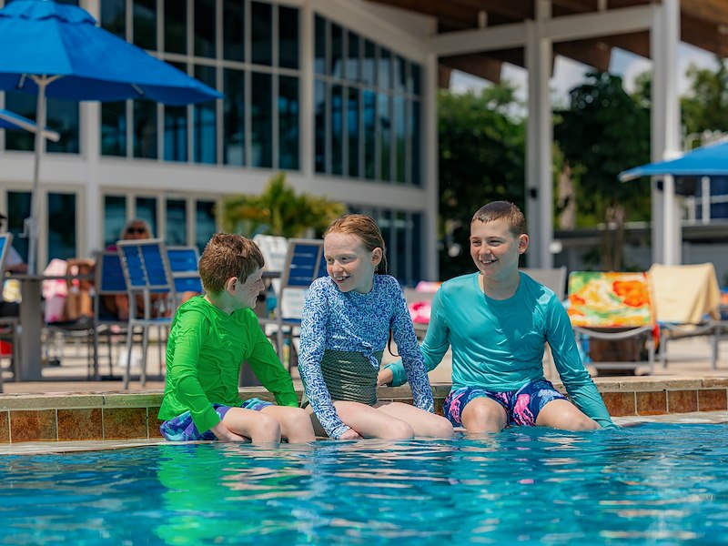 Guests enjoying the outdoor pool at Sun Outdoors Sarasota