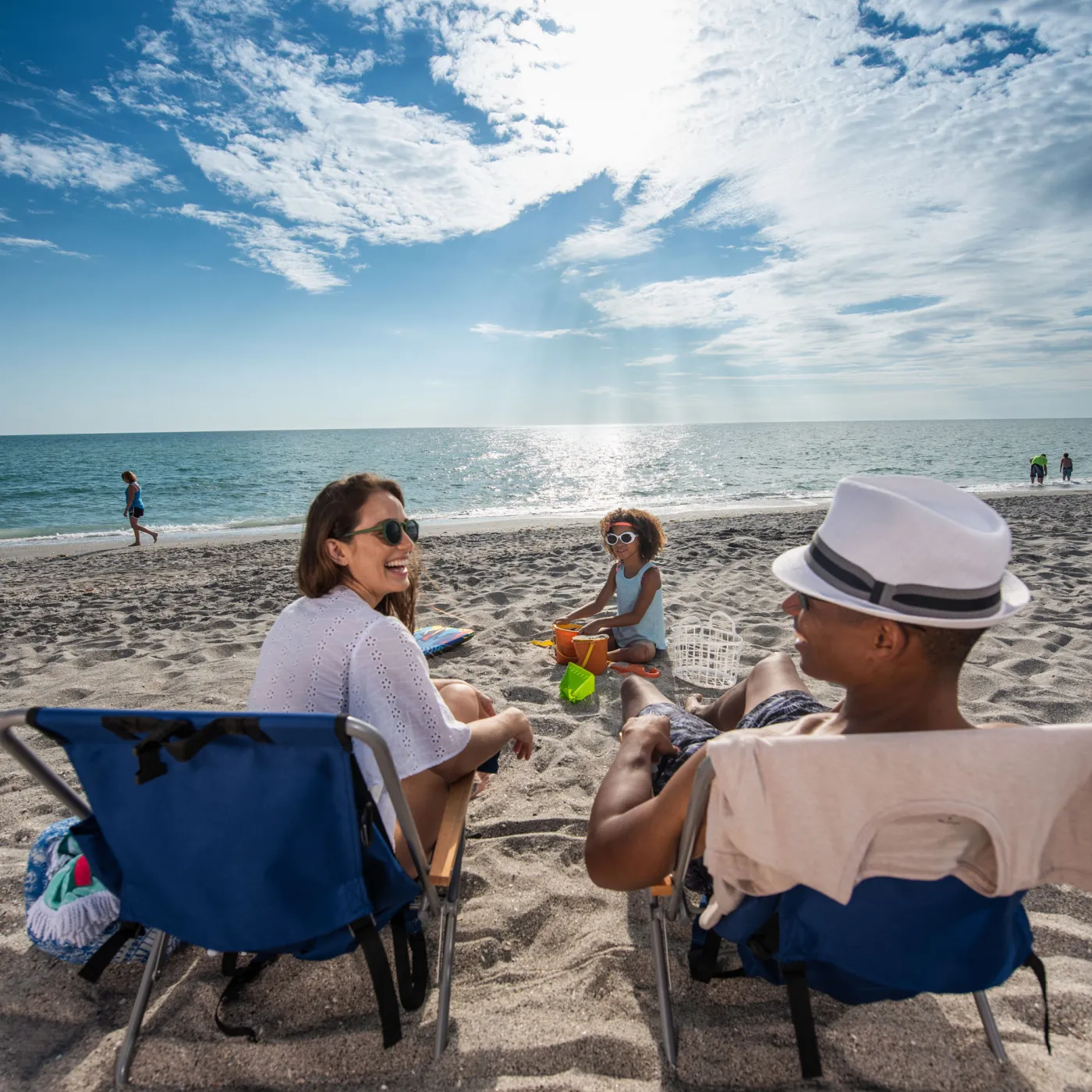 Couple relaxing on beach chairs at Siesta Beach